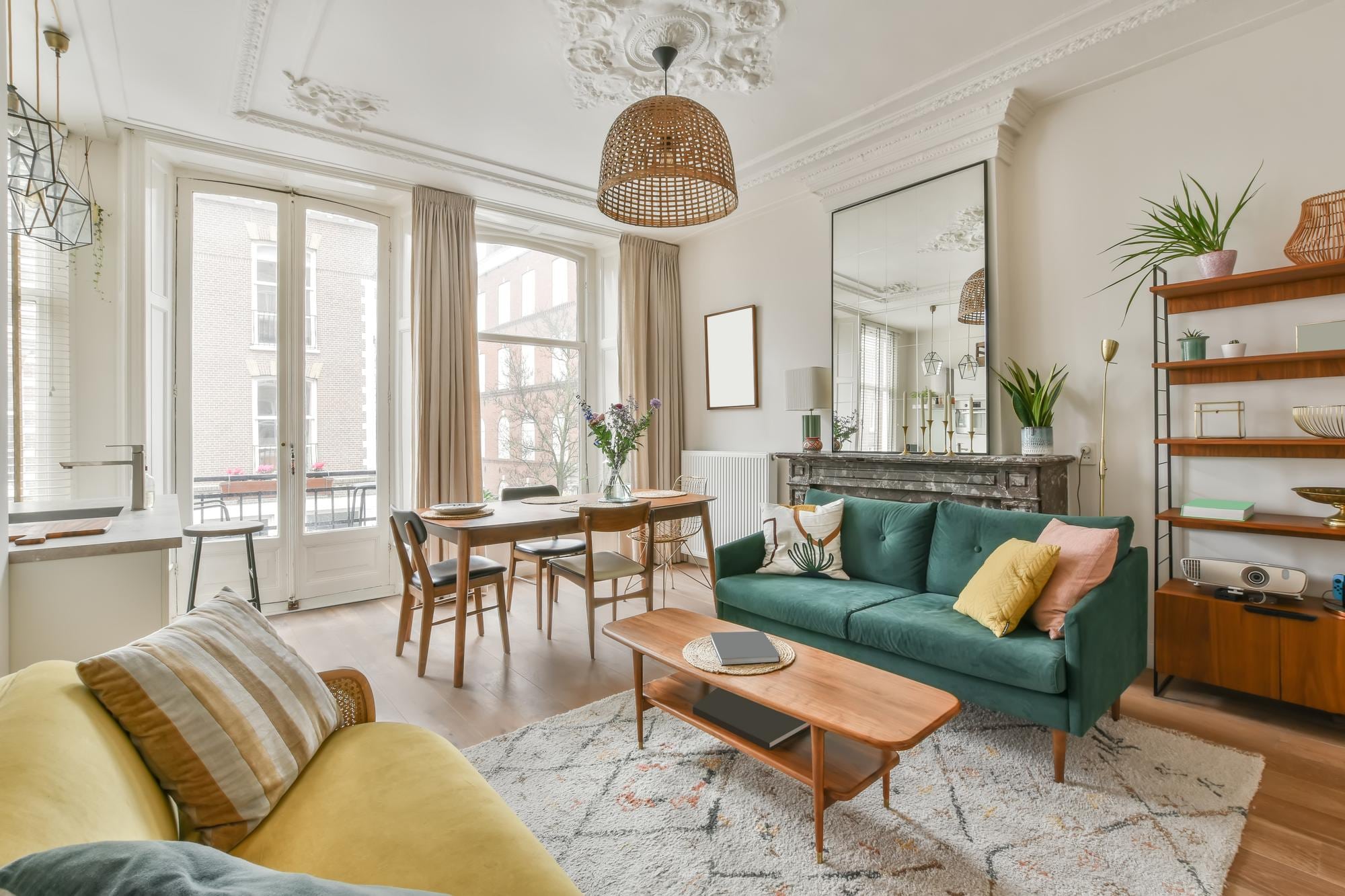 A interior of a living room with warm light, tall ceilings and colorful furnature
